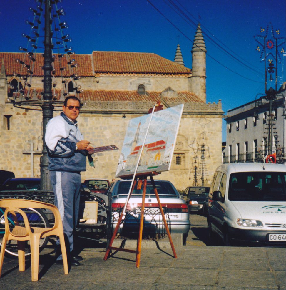 Cristóbal Valle pintando ante la fachada de la Catedral de la Sierra